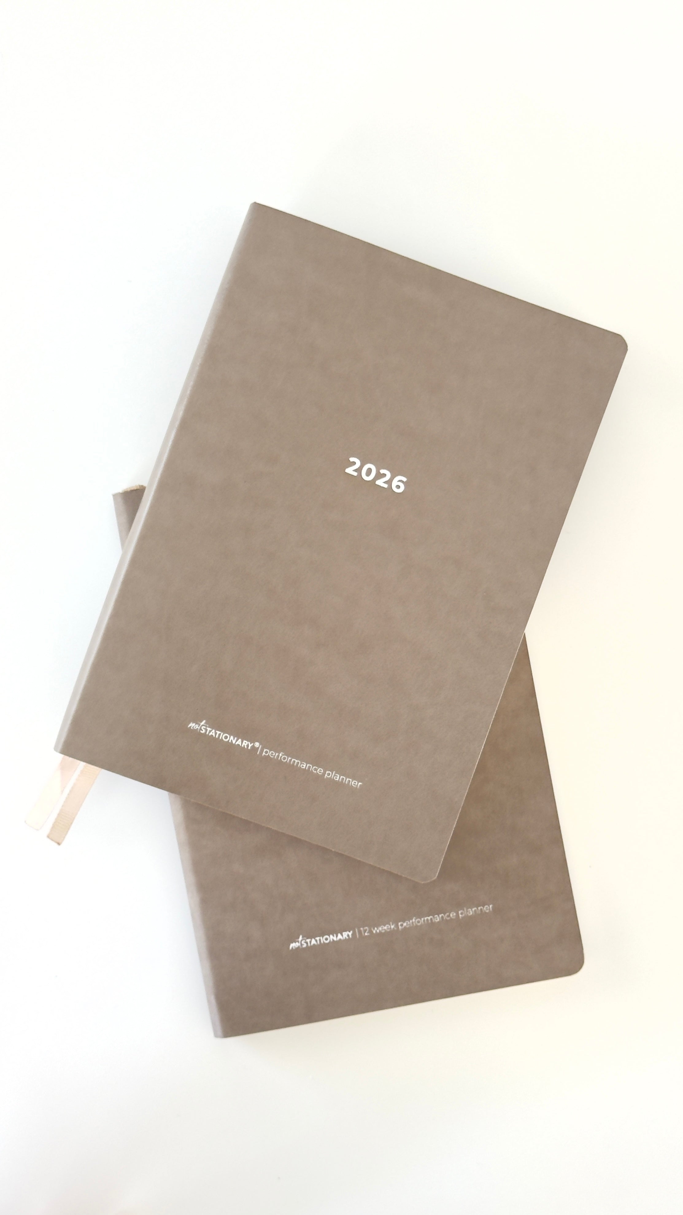 Two brown 2026 planners stacked on a white background