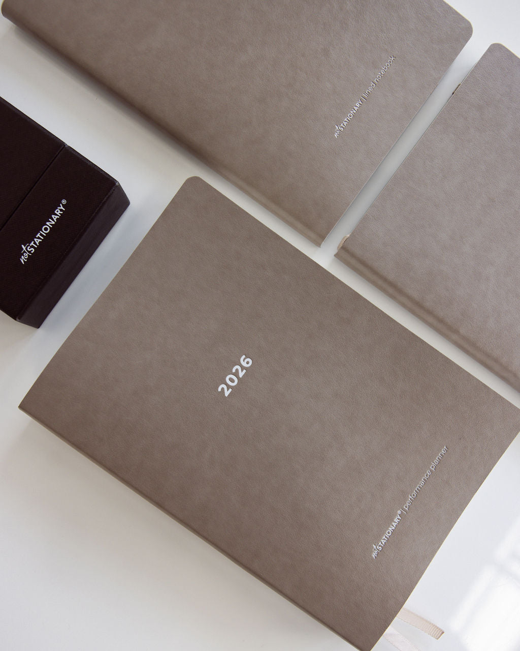 2026 Not Stationary Performance Planners in minimalist stone covers with ribbon bookmarks, designed for intentional living and high performance.