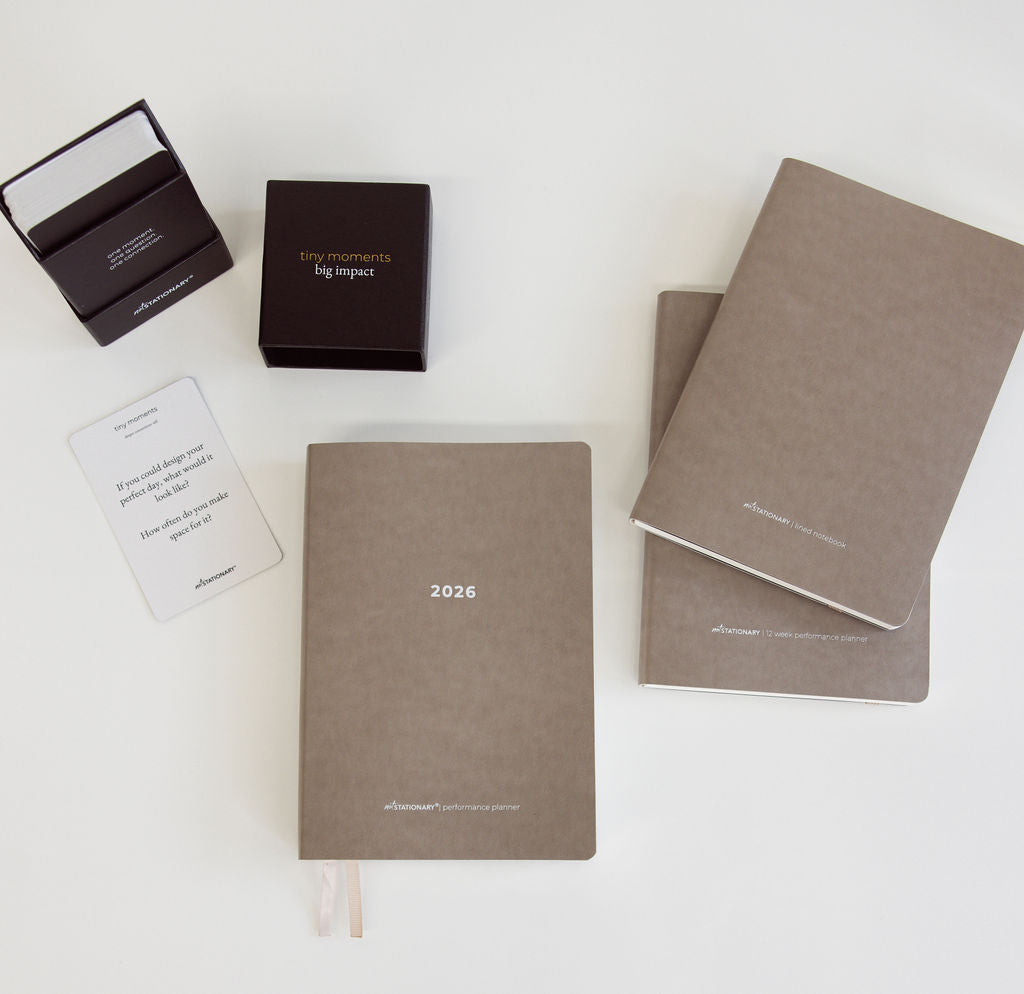 Set of brown notebooks with '2026' and 'tiny moments' branding on a white background