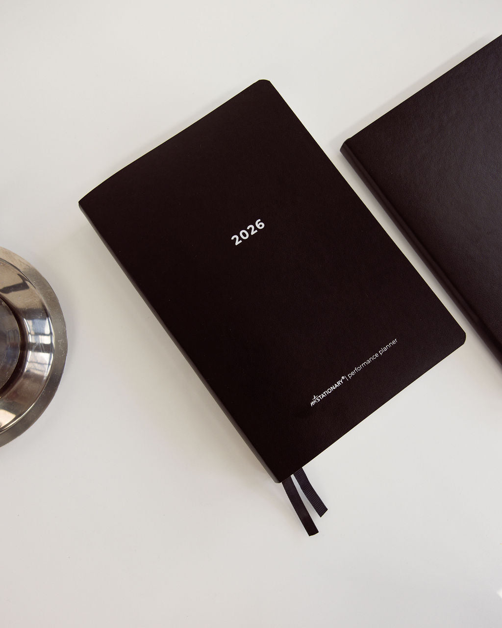 2026 Not Stationary Performance Planners in minimalist black with ribbon bookmarks, designed for intentional living and high performance.