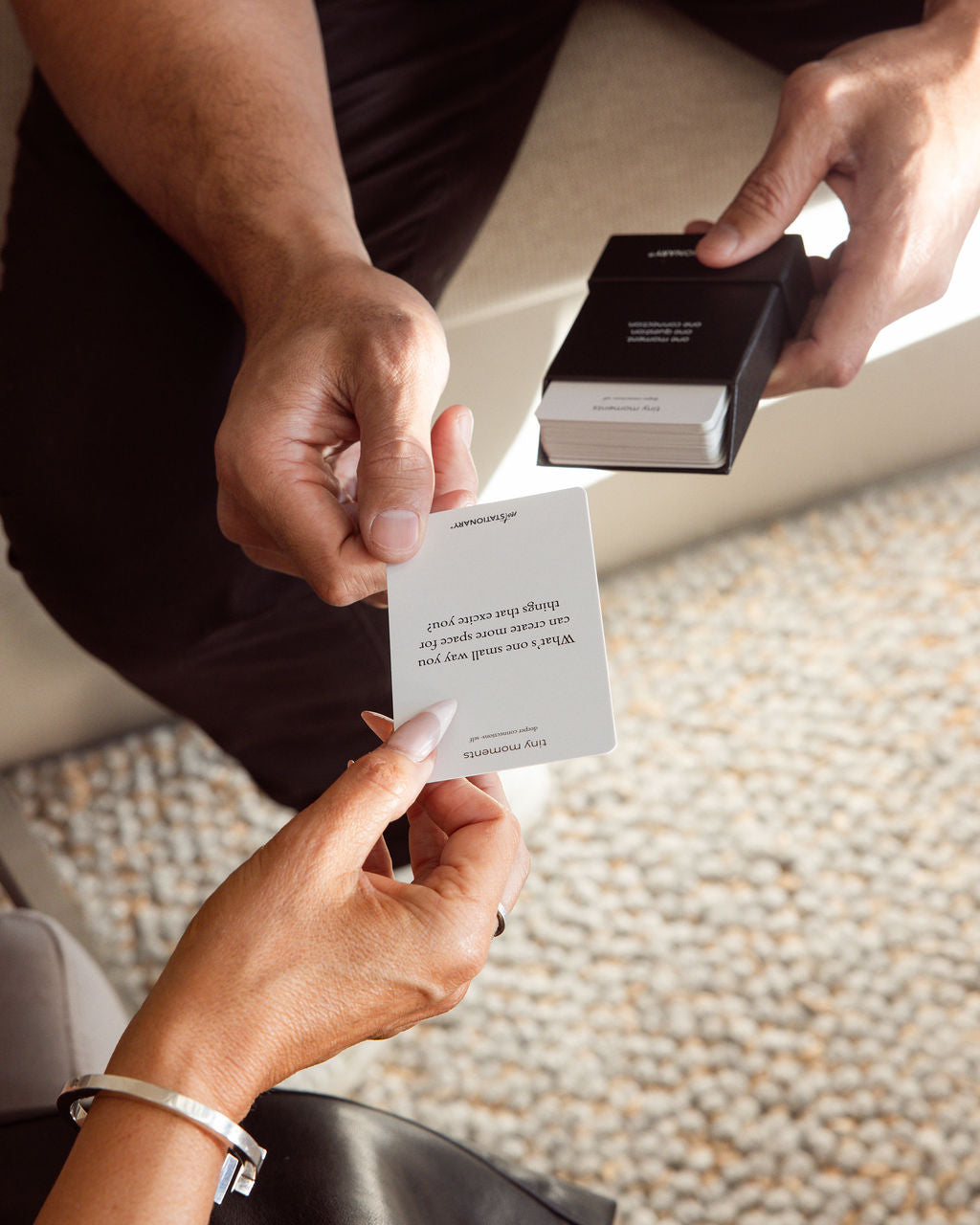 Two people holding Tiny Moments™ Deeper Connections cards – a guided tool for meaningful conversations and relationships