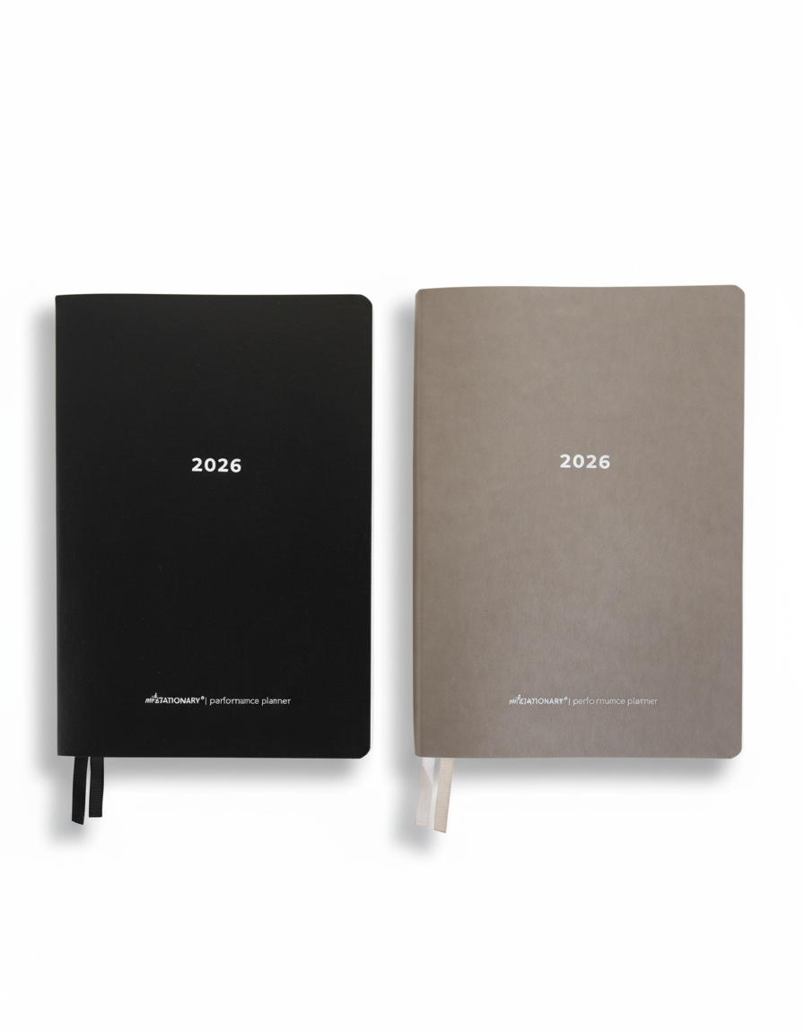 2026 Not Stationary Performance Planners in minimalist black and stone covers with ribbon bookmarks, designed for intentional living and high performance.