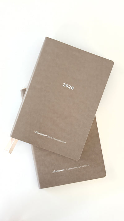 Two brown 2026 planners stacked on a white background