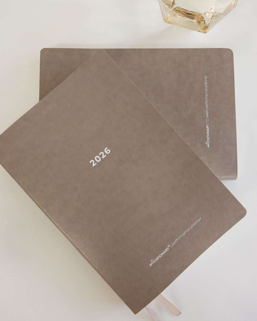 Two brown diaries with '2026' printed on them, placed on a light surface.