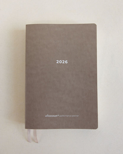 2026 Not Stationary Performance Planners in minimalist stone cover with ribbon bookmarks, designed for intentional living and high performance.