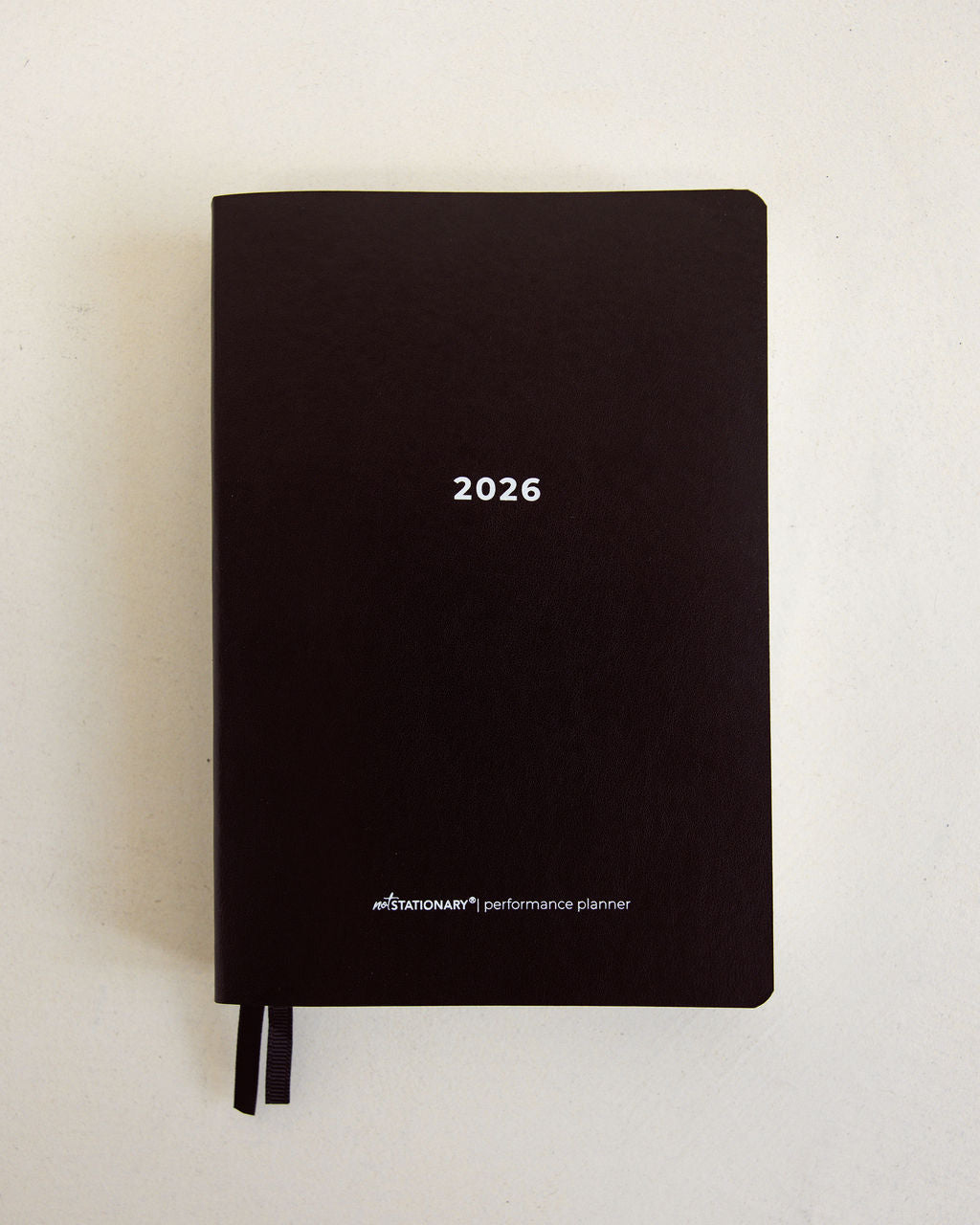 2026 Not Stationary Performance Planners in minimalist black with ribbon bookmarks, designed for intentional living and high performance.
