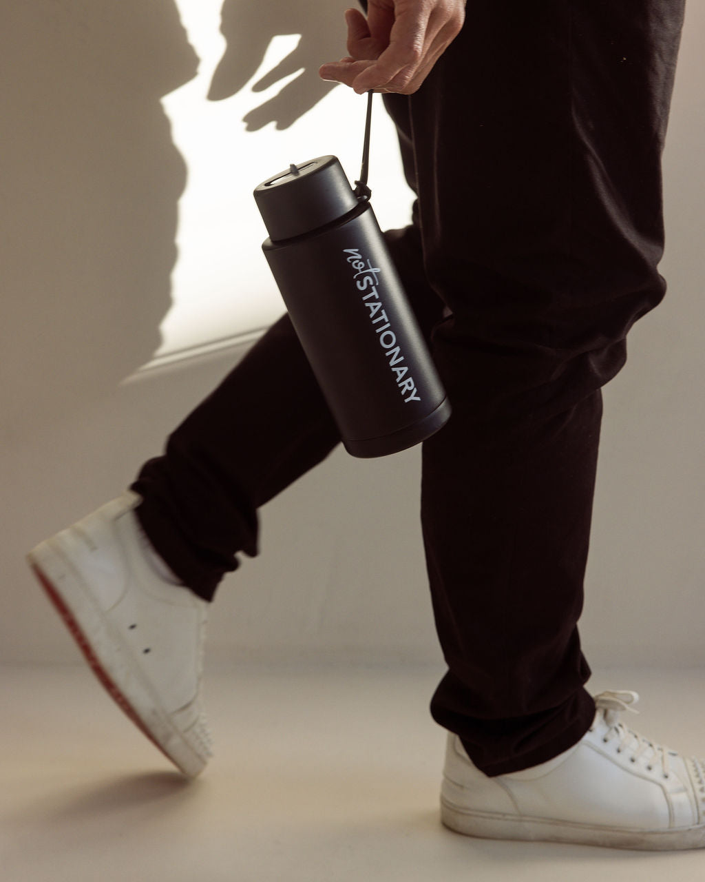 Martin carrying the Not Stationary Signature Drink Bottle — double-walled, insulated, and designed for high-performance routines.
