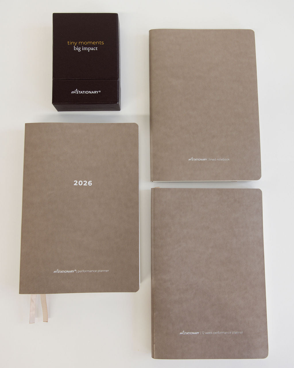 Four brown planners with '2026' on one of them, displayed on a white background.