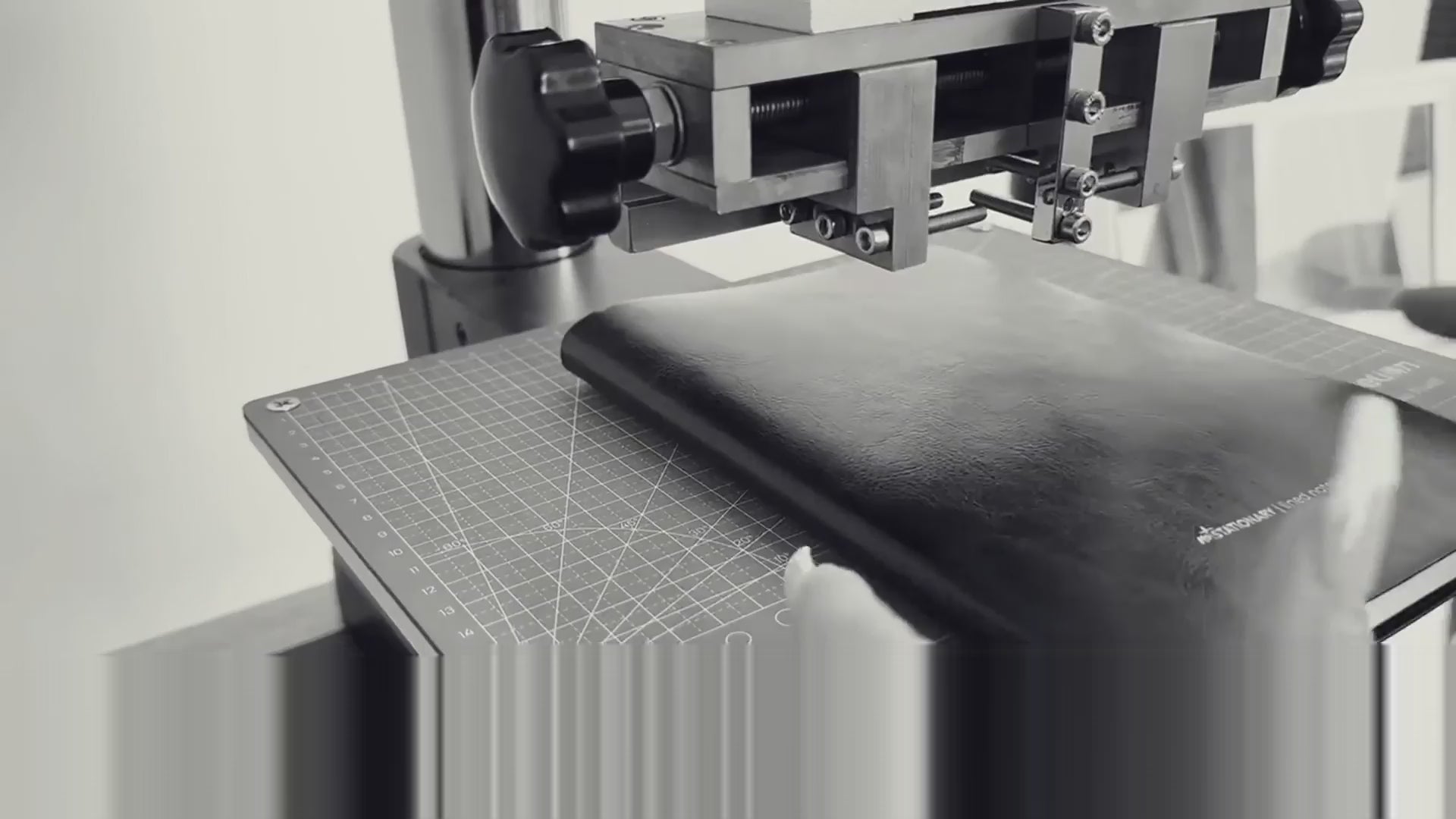 Load video: Close-up of Not Stationary planner being monogrammed with custom initials using a heat press.